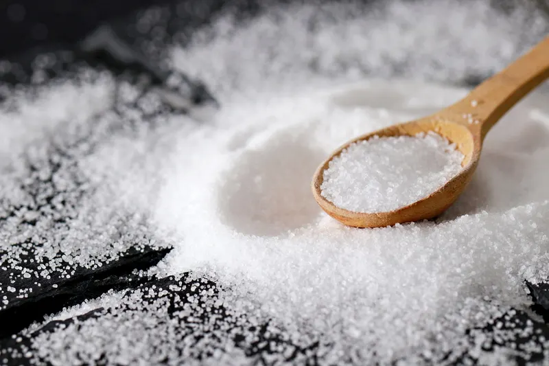 Fine salt on a wooden spoon